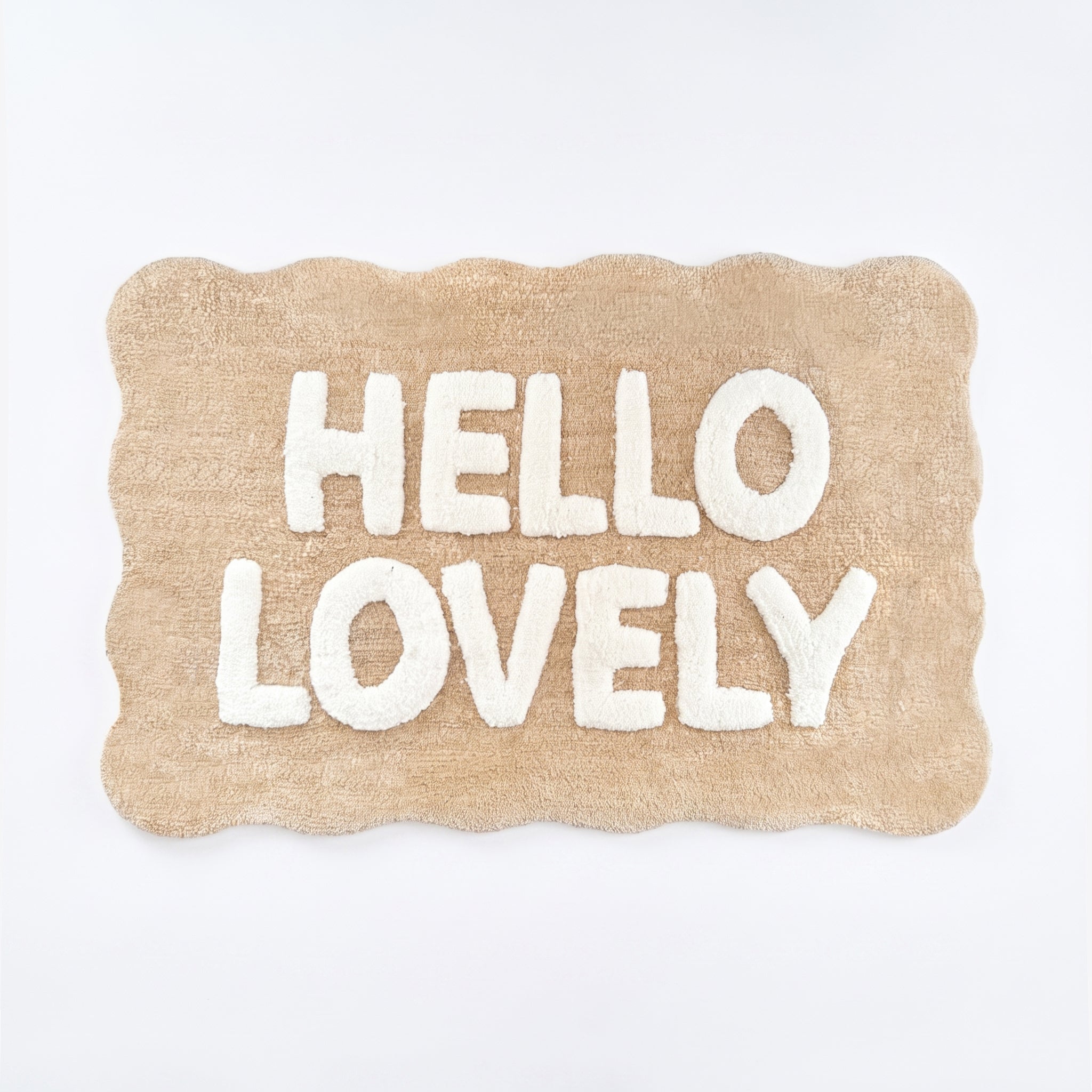 Beige and white scalloped bath mat with hello lovely slogan.