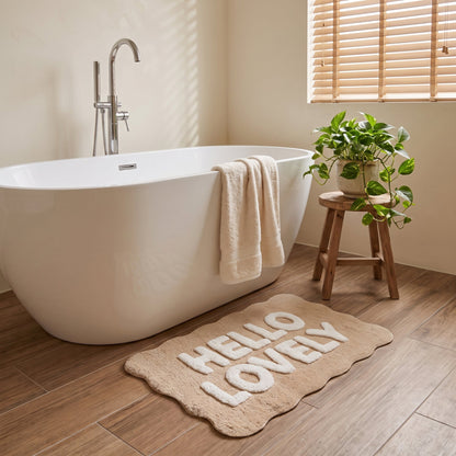 Beige slogan bathroom mat with scalloped edges - fun hello lovely slogan.