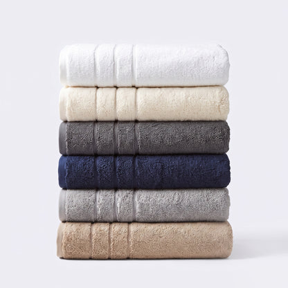 Stack of quality hotel style towels showing the six staple colours. Thick towels made from 100% cotton.