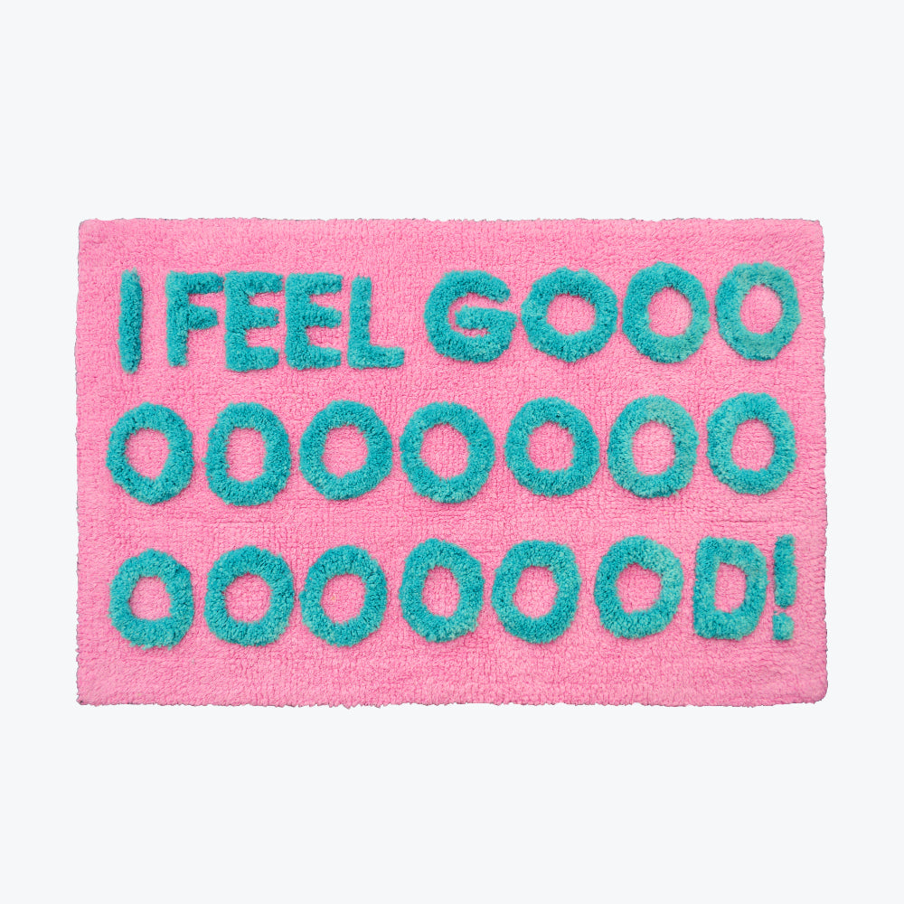 Pink bath mat, hand tufted slogan design with positive I feel good slogan.