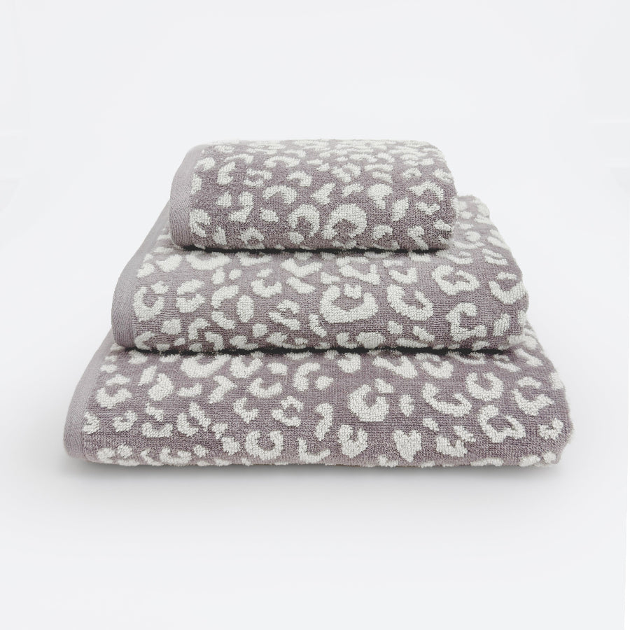 Set of three leopard print towels for the bathroom in various sizes - hand towel, bath towel, bath sheet.