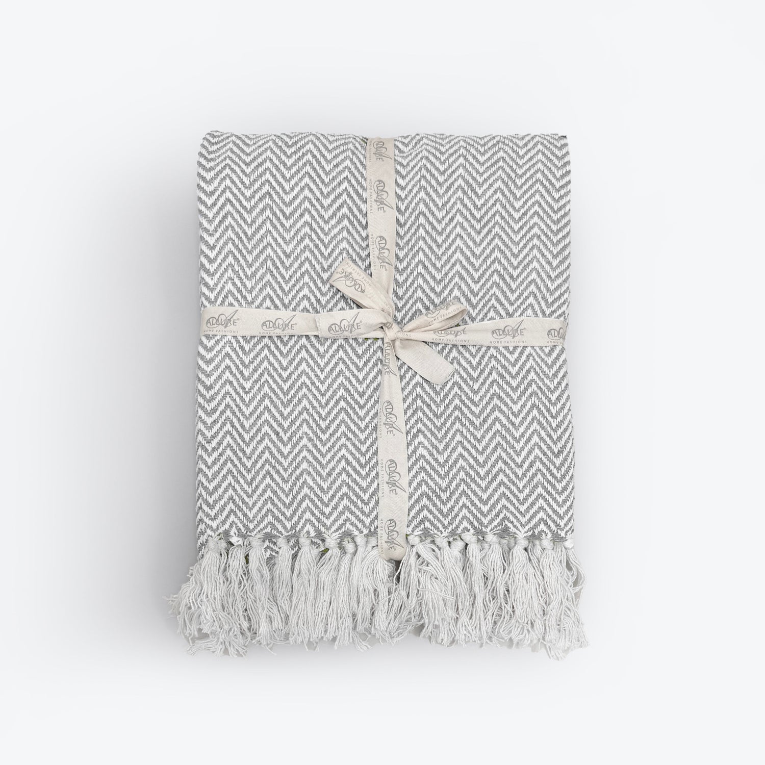 Off white and grey herringbone blanket made from cotton. White chevron throw with tassels. 