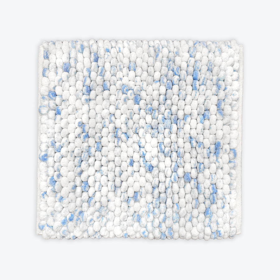 Blue and white small square bath mat in chunky bobble textured design.