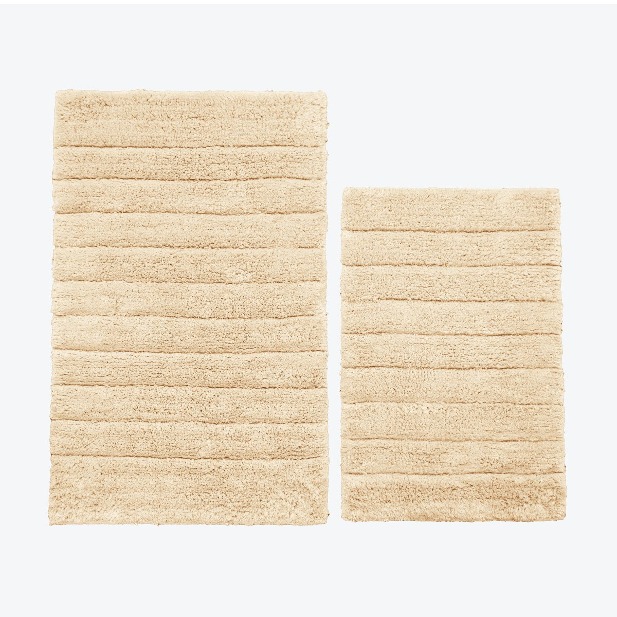 Beige two piece bath mat set.