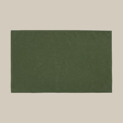 Dark green bath mat made from organic cotton. Soft and sustainable bathroom accessories.