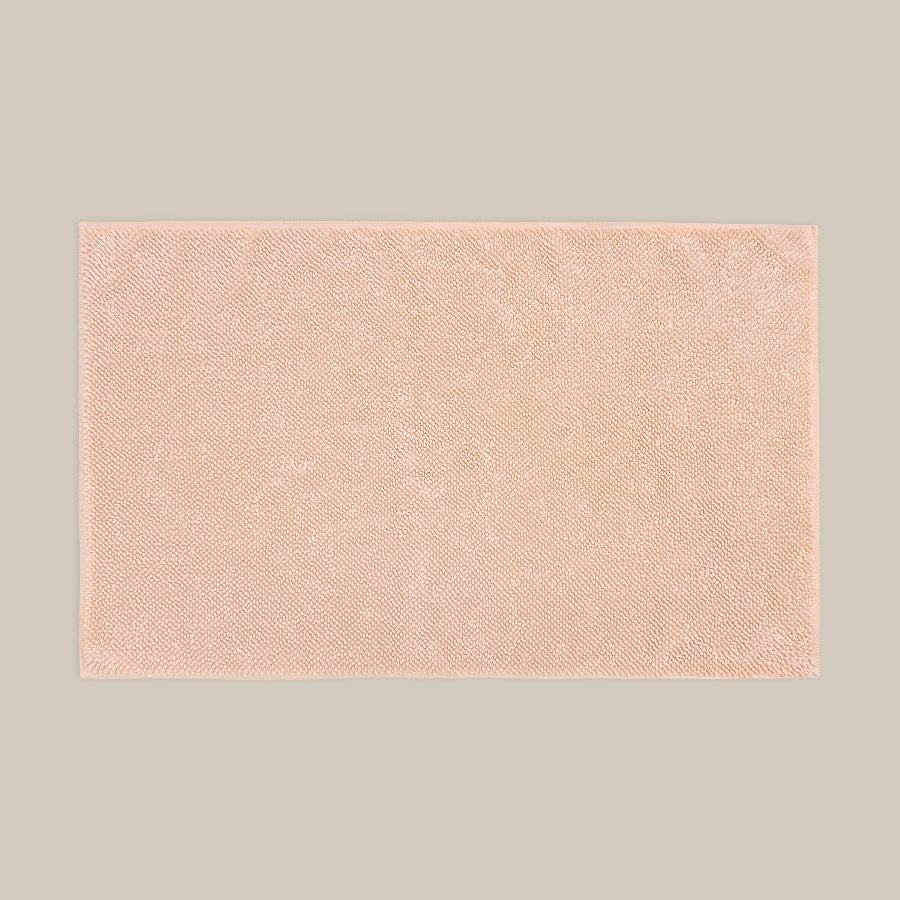 Blush pink bath mat made from organic cotton. Soft and sustainable bathroom accessories.