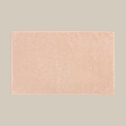 Blush pink bath mat made from organic cotton. Soft and sustainable bathroom accessories.