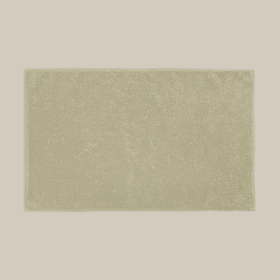 Sage green bath mat made from organic cotton. Soft and sustainable bathroom accessories.