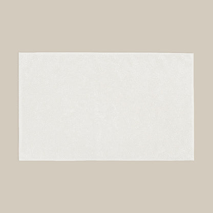 White bath mat made from organic cotton. Soft and sustainable bathroom accessories.