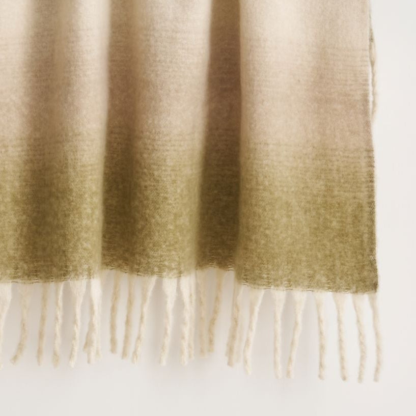 Green throw blanket, mohair synthetic.