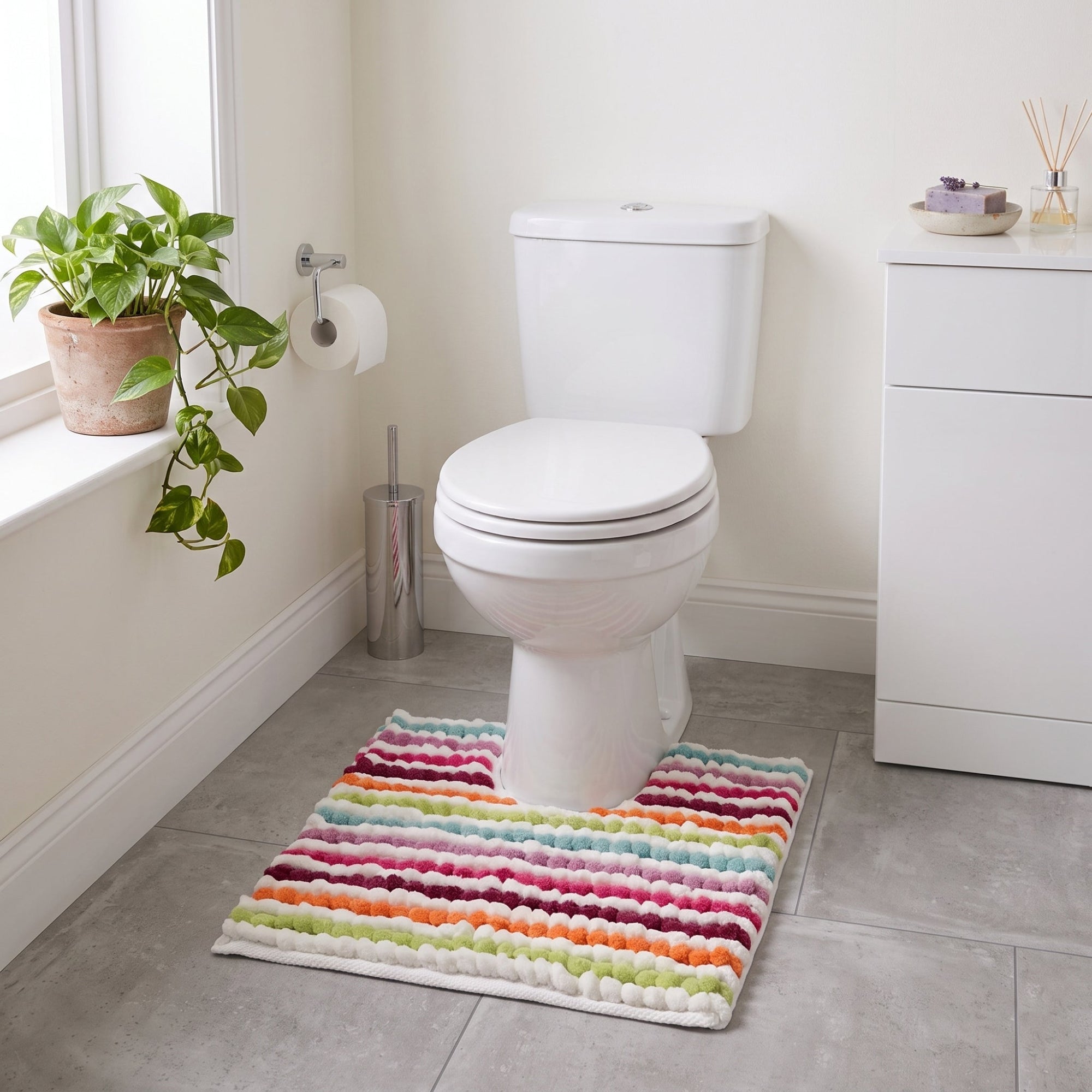 Multi-coloured chunky bobble pedestal mat for the toilet.
