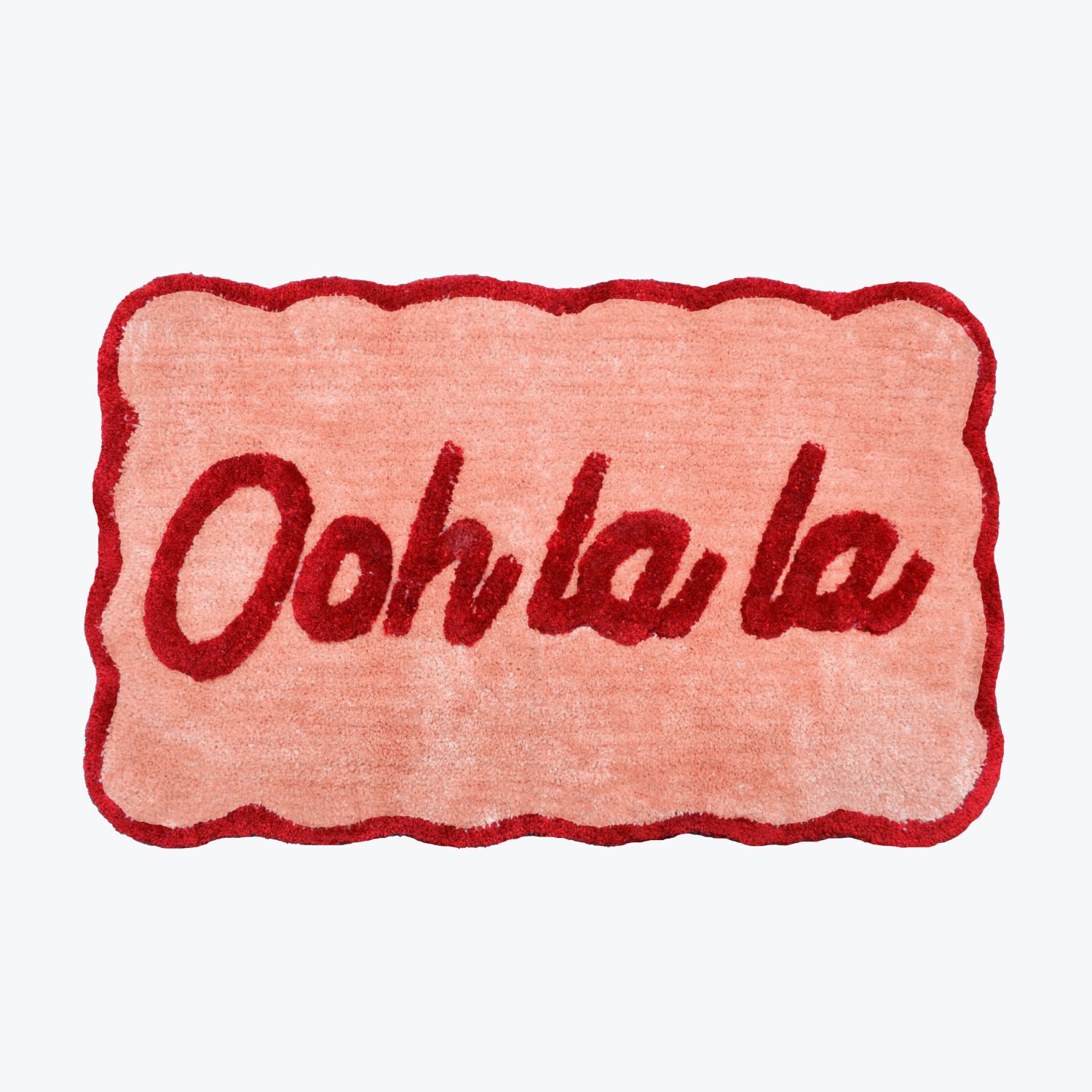 Red and pink bath mat, scalloped. Hand tufted slogan mat with ooh la la phrase.
