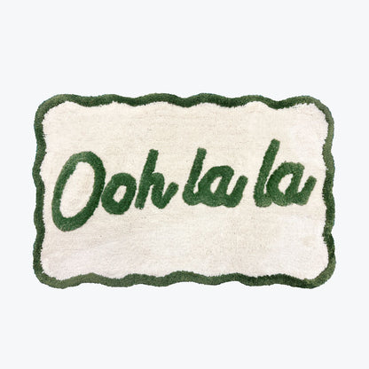 Ooh la la slogan mat with scallop edges in green and cream.