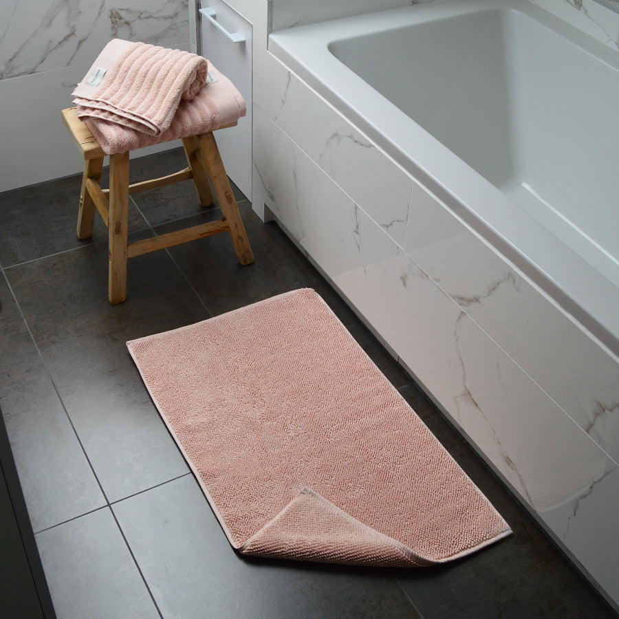 Pink bath mat made from organic cotton. Modern, sustainable homeware.