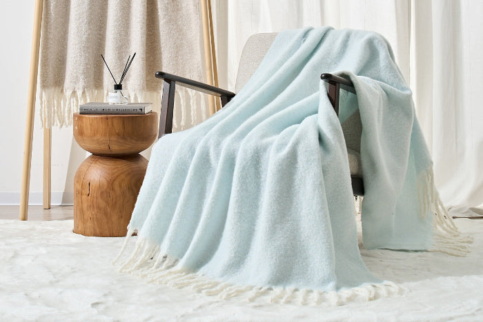 Light blue throw blanket draped over a chair.