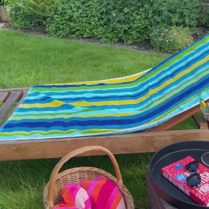 a video of velour beach towels on a sunlounger