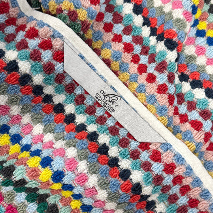 Colourful recycled cotton towels with hanging loop for quick drying.