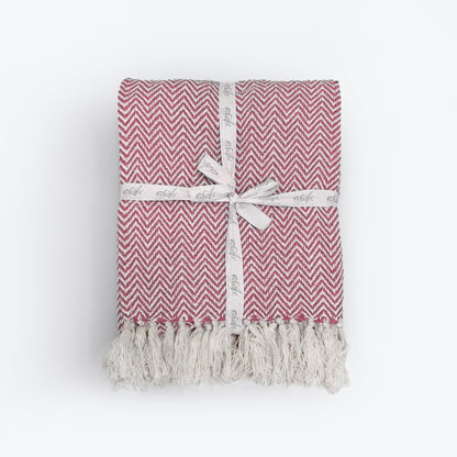 Red Audley chevron herringbone throw with tassels. 