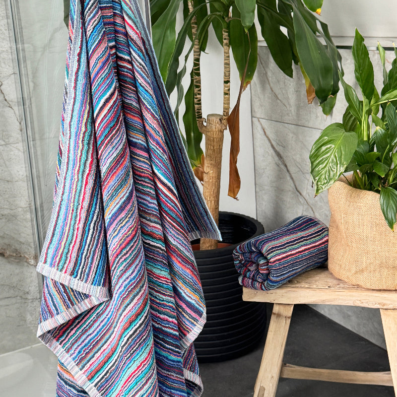Striped bathroom towels made from sustainable recycled cotton - blue, pink, red stripes.