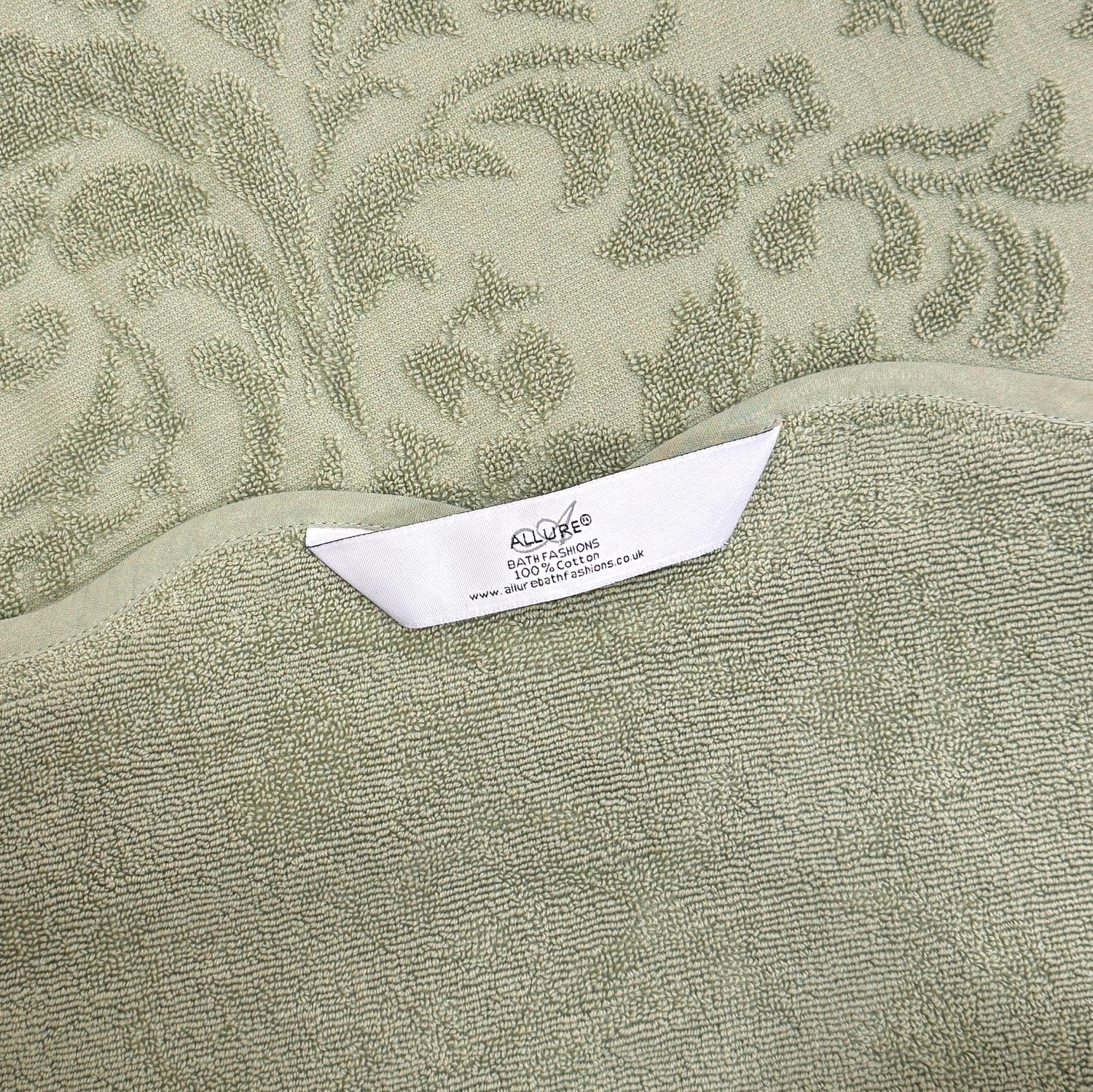 Sage green bathroom towels with hanging loops, made from 100% cotton and finished with a floral jacquard pattern.