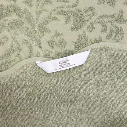 Sage green bathroom towels with hanging loops, made from 100% cotton and finished with a floral jacquard pattern.
