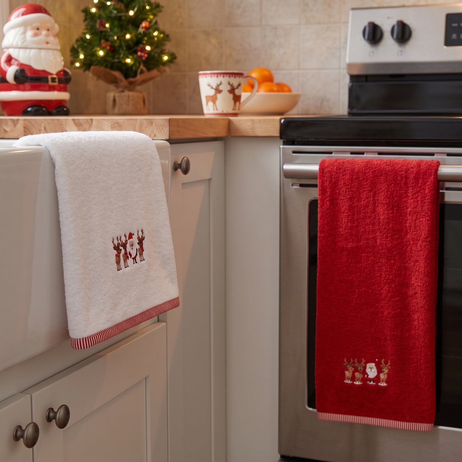 Set of two christmas towels in red and white colours with santa and reindeer design.