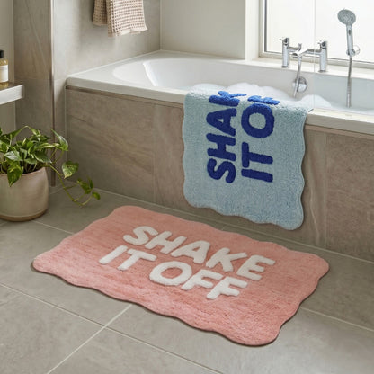 Fun bath mats with shake it off slogan in blue and pink colour options.