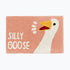 Blush pink silly goose slogan bath mat with white honking goose.