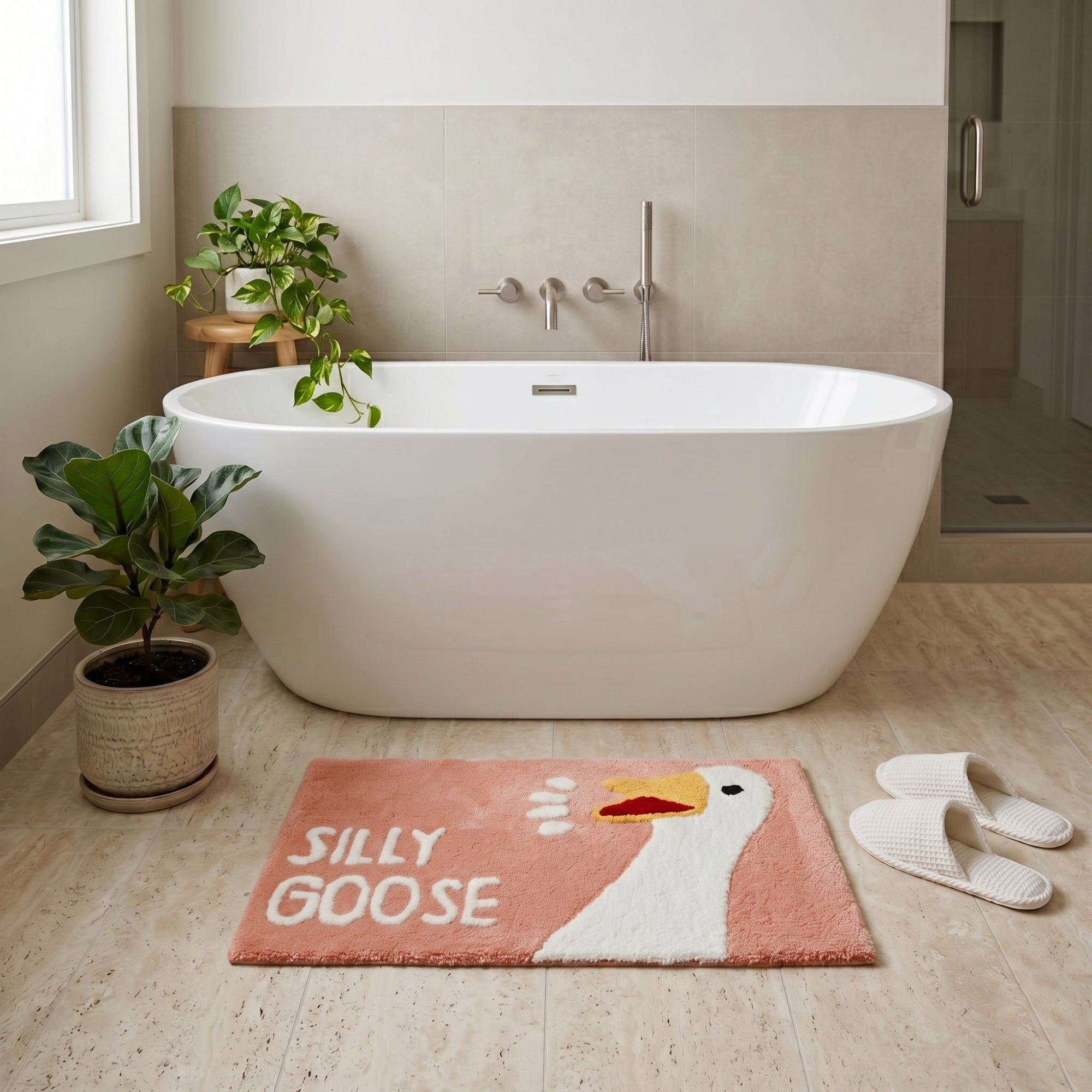 Blush pink novelty bath mat with silly goose character.