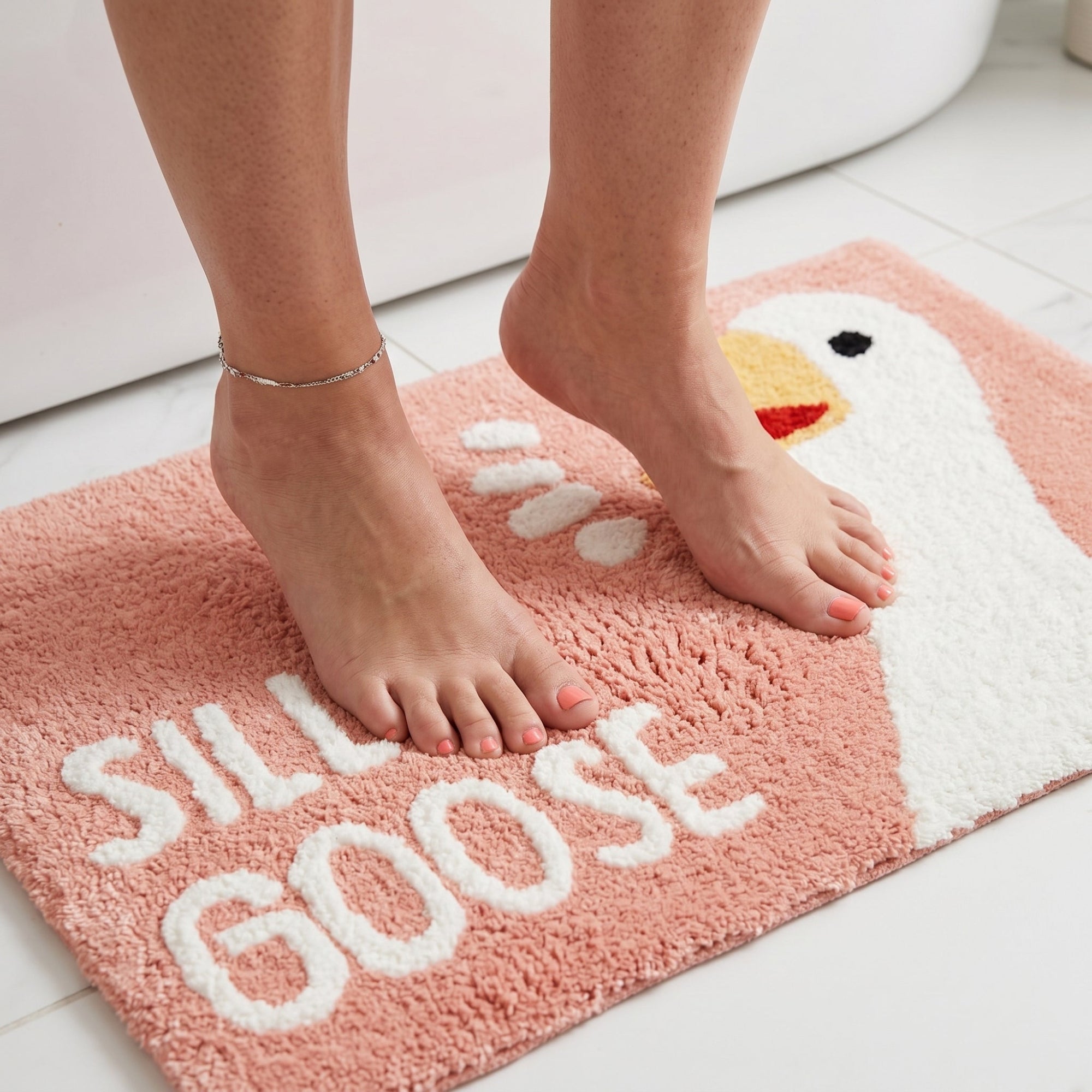 Soft silly goose bath mat in blush pink.