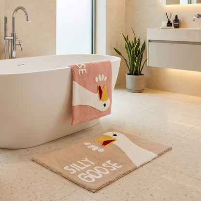 Beige or pink silly goose bath mats styled in a neutral bathroom.