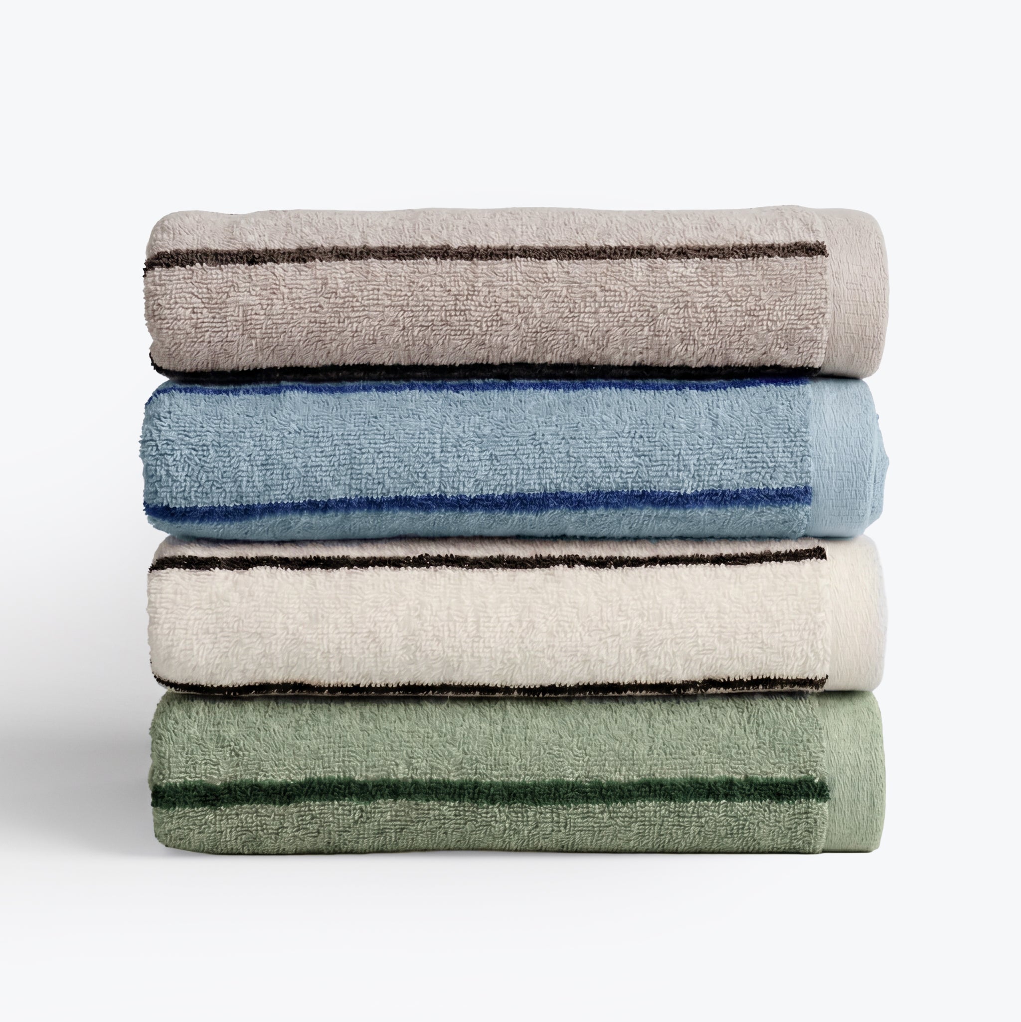 Stack of towels in mixed colours with striped pattern design, beige, blue, cream, green.