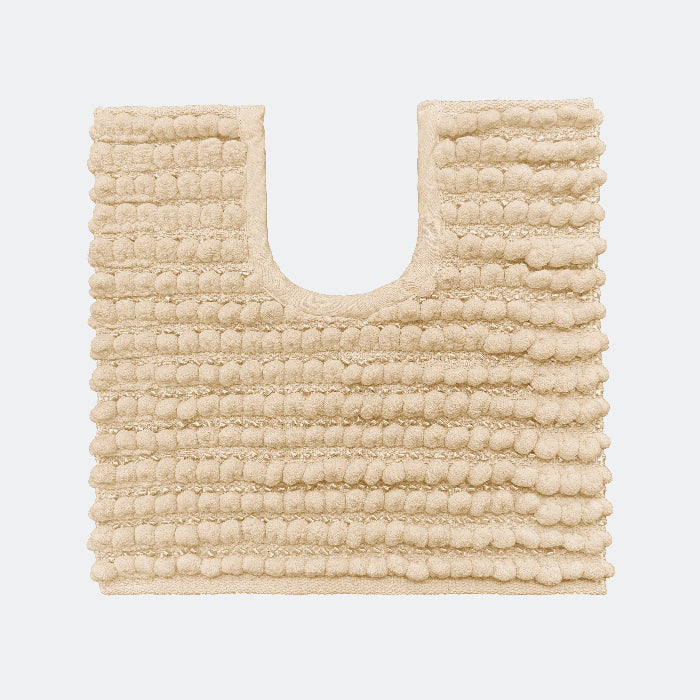 Beige pedestal toilet mat made from chenille - chunky bobble design.