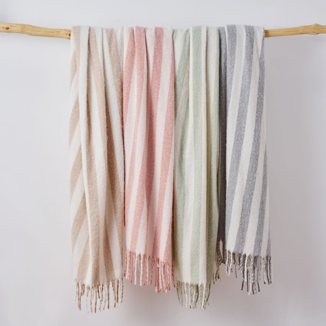 Soft faux mohair throw blankets in colourful stripe pattern.