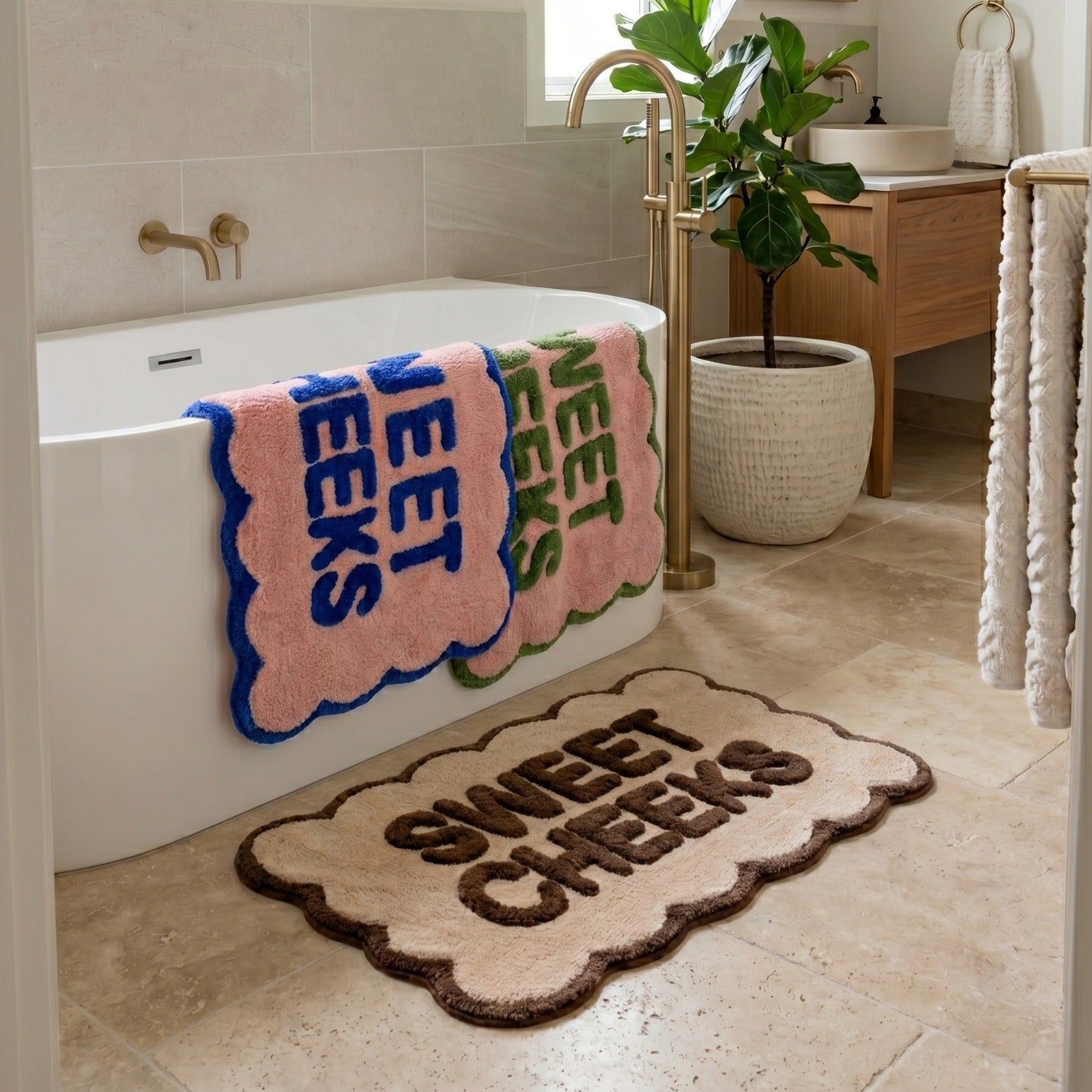 sweet cheeks scalloped bath mats in 3 colours shown in a bathroom setting