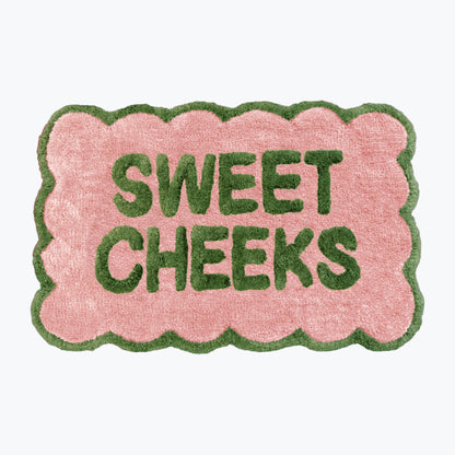 Pink and green bathroom mat with fun sweet cheeks slogan - scalloped rug.