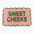 Pink and green bathroom mat with fun sweet cheeks slogan - scalloped rug.