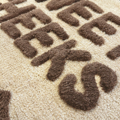 Brown and beige slogan bath mat with sweet cheeks text - super soft and absorbent tufted mat.