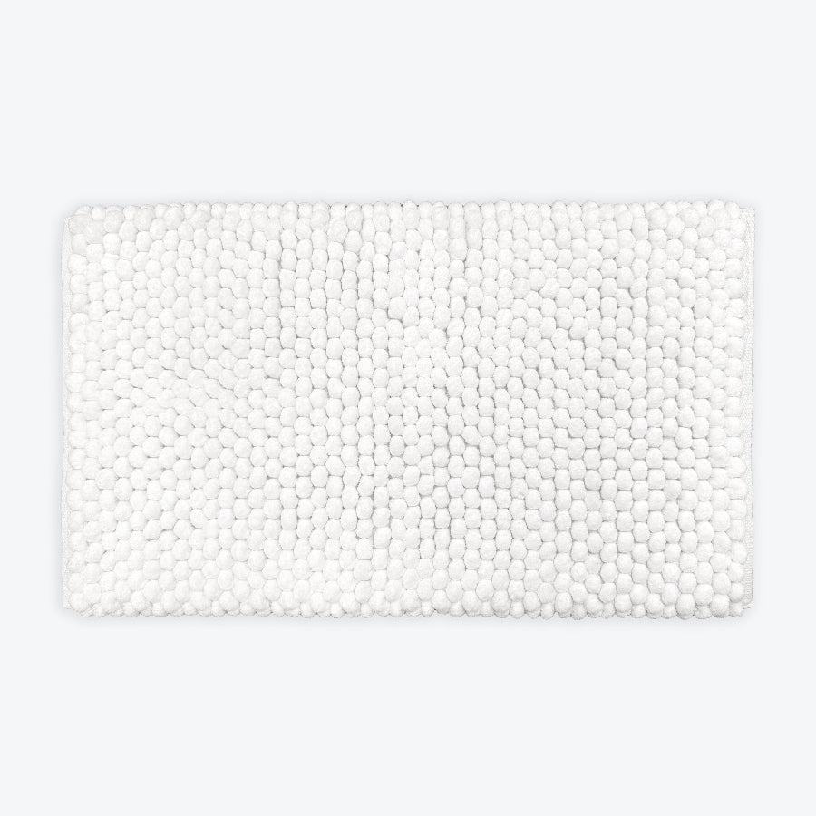 White thick bath mat with luxury bobble texture. Super soft and absorbent washable rug.
