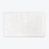White thick bath mat with luxury bobble texture. Super soft and absorbent washable rug.