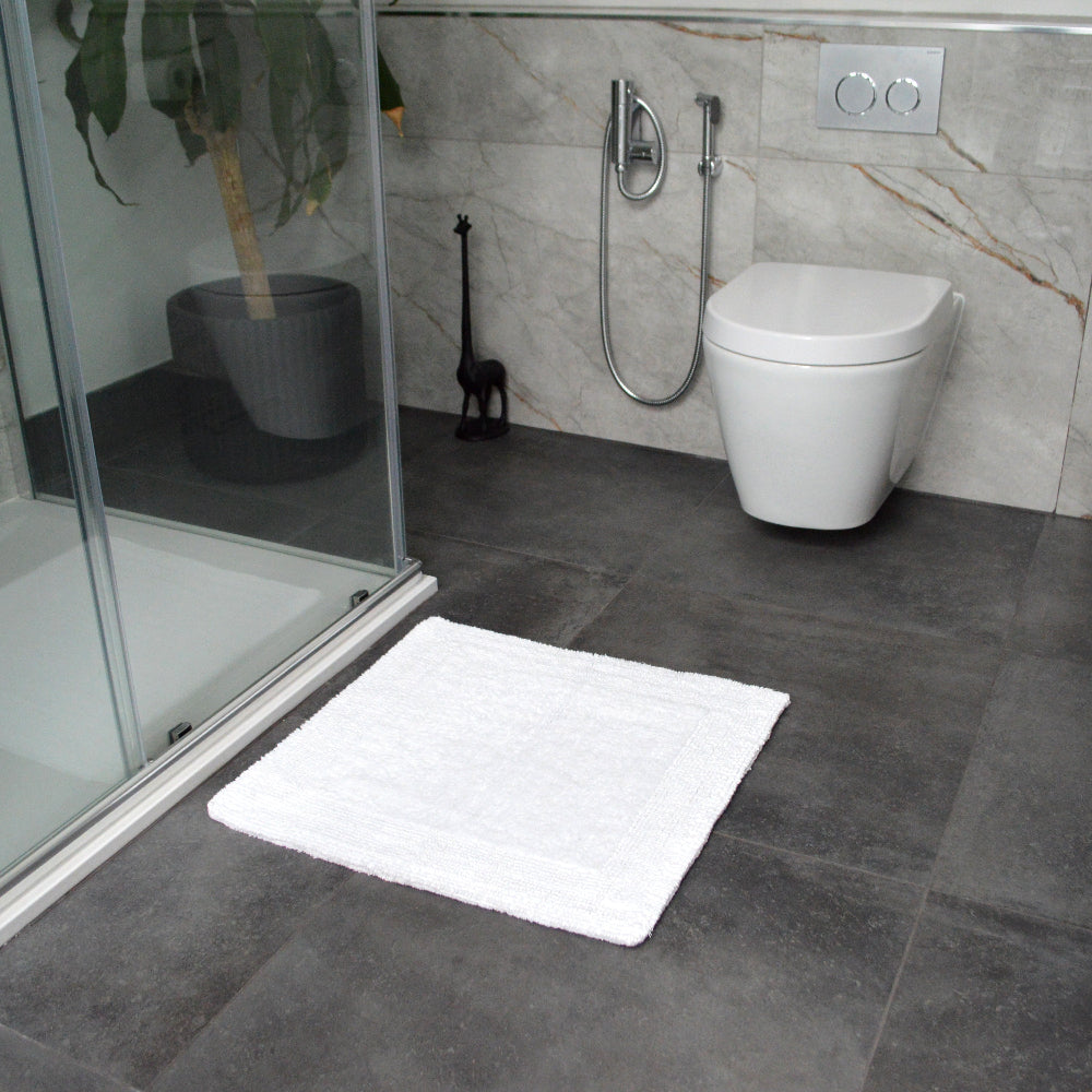 White square shower mat, small bathmat.