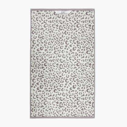 Grey and white leopard print towels with hanging loops.