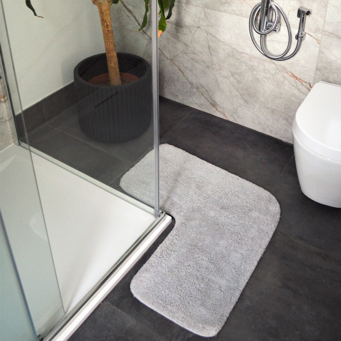 Dove grey corner shaped bath mat for shower unit