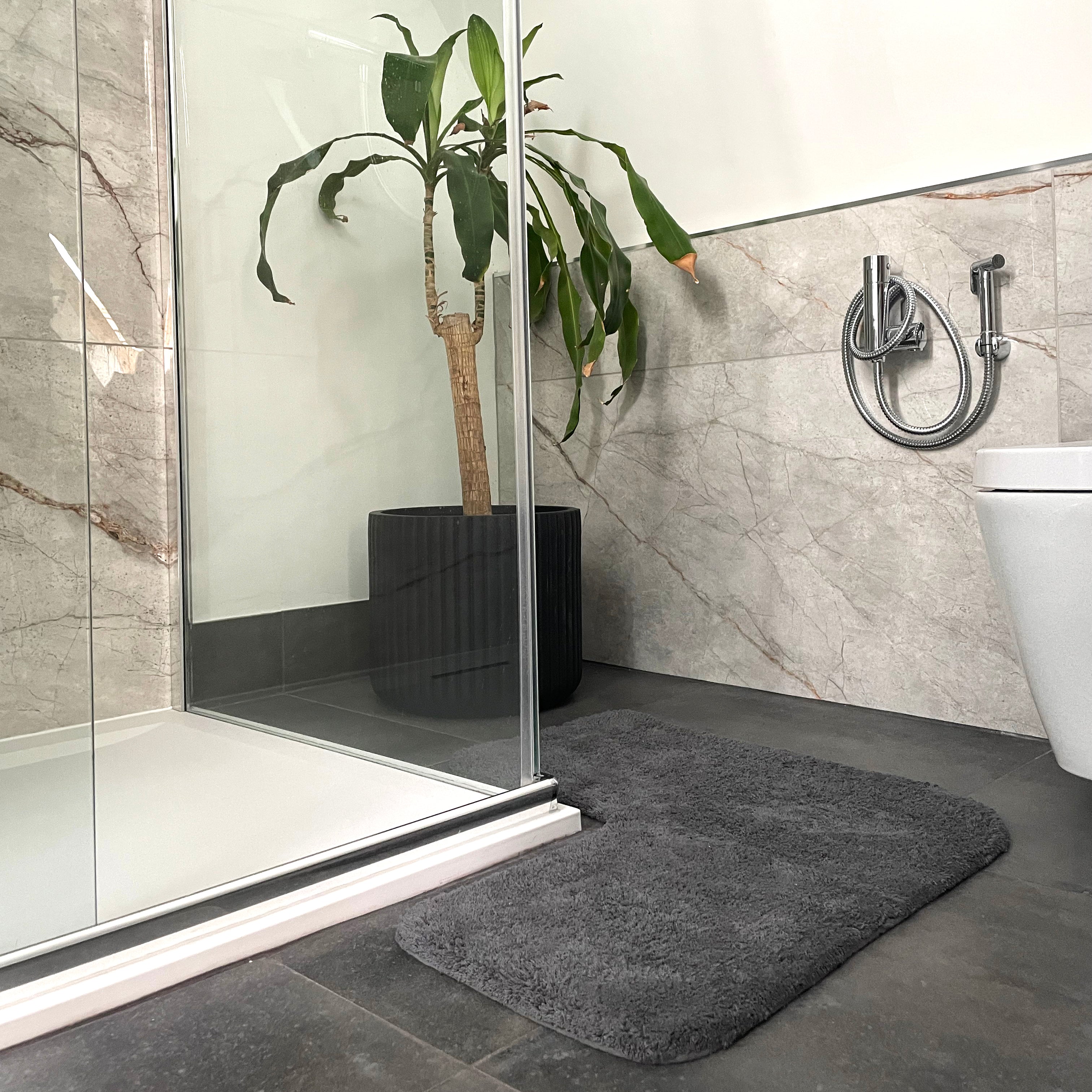 Charcoal grey corner shaped bath mat for shower unit