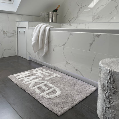 Grey get naked bath mat in monochrome bathroom.